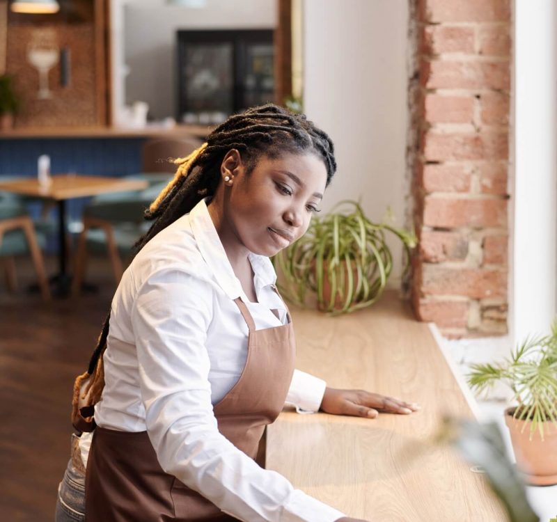 young-black-waitress-cleaning-table.jpg